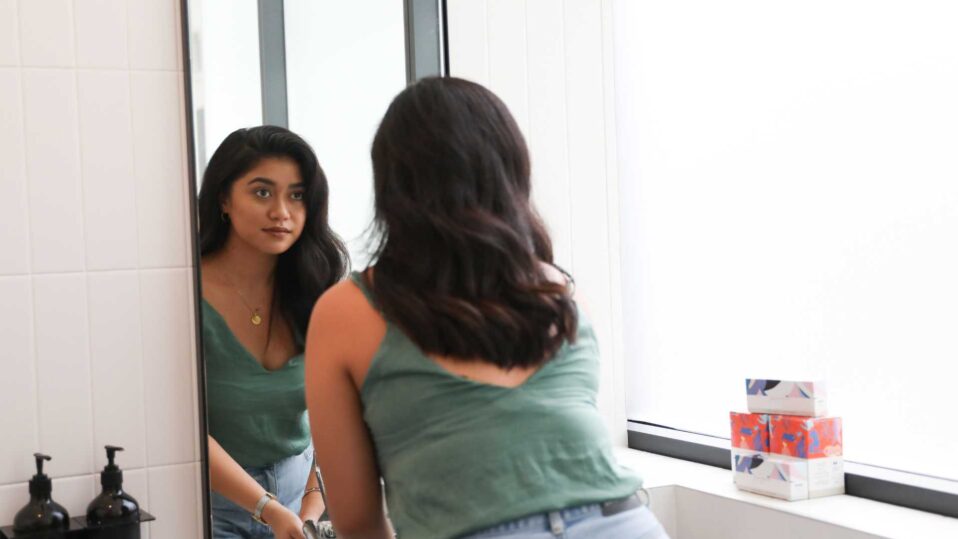 woman in front of a mirror