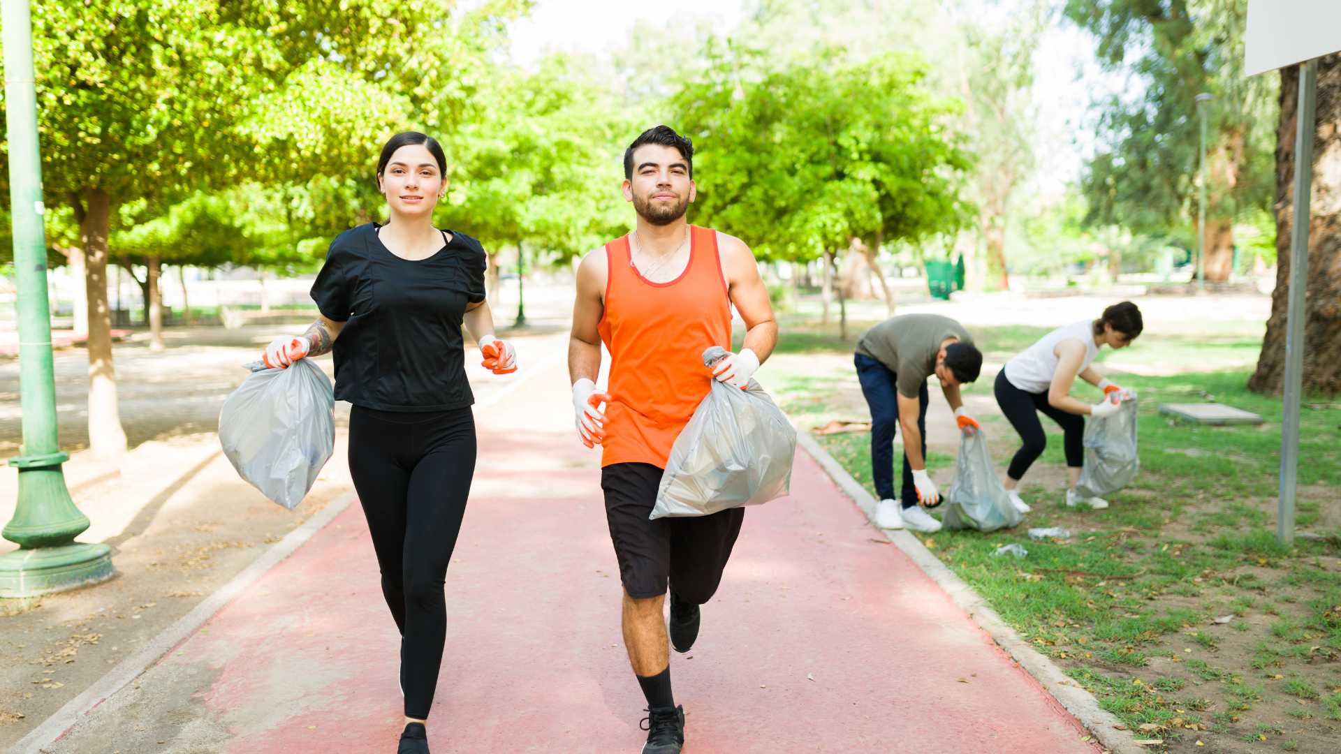 group of people jogging and picking up litter