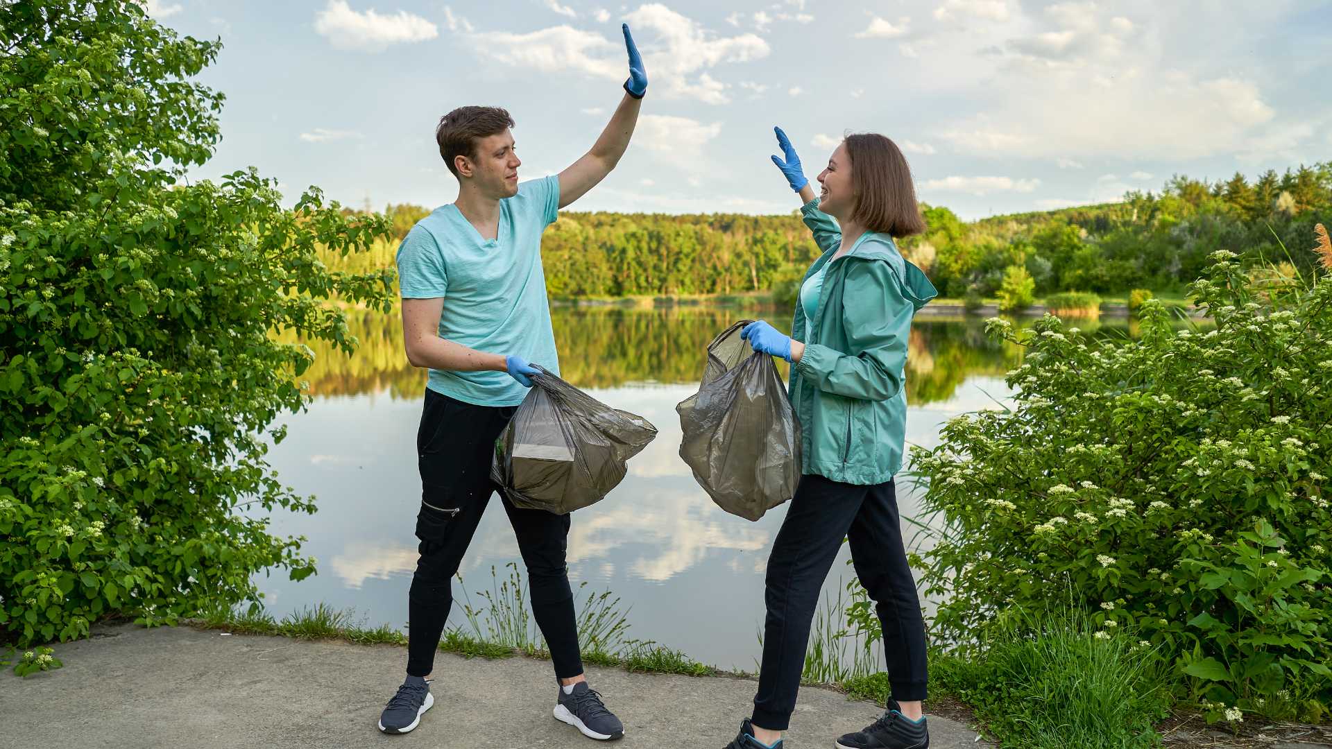 group of people jogging and picking up litter