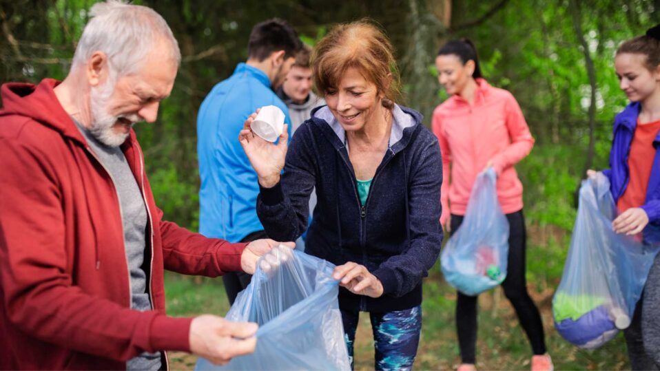 group of people jogging and picking up litter