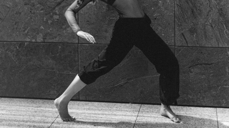 woman walking barefoot in the street